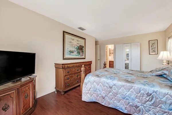 a bedroom with a bed and a flat screen tv