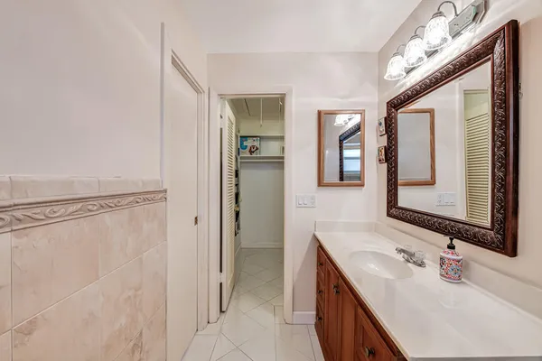 a bathroom with a double vanity sink a mirror and a shower