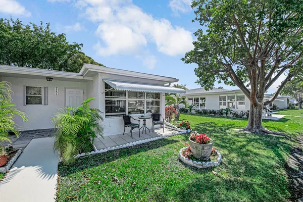 a front view of house with yard and outdoor seating