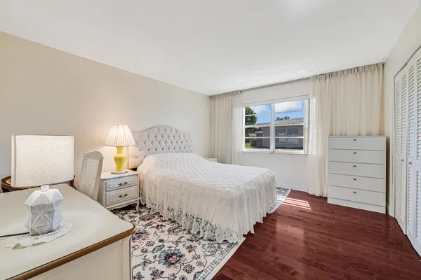 a bedroom with a bed and a lamp