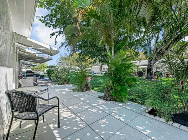 a backyard of a house with a garden and plants