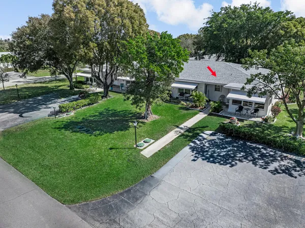 a front view of a house with a yard and trees