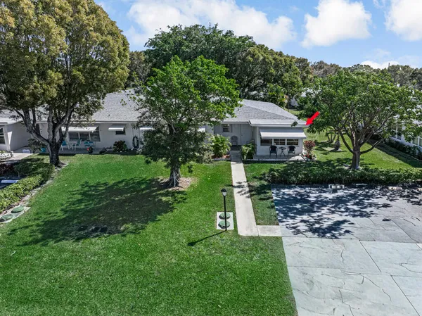 an aerial view of a house with yard and outdoor seating