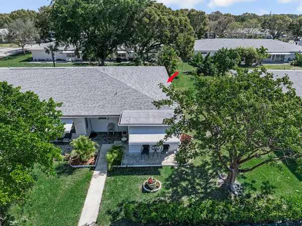 an aerial view of a house with a yard and garden
