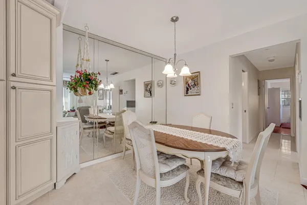a view of a dining room with furniture and a chandelier