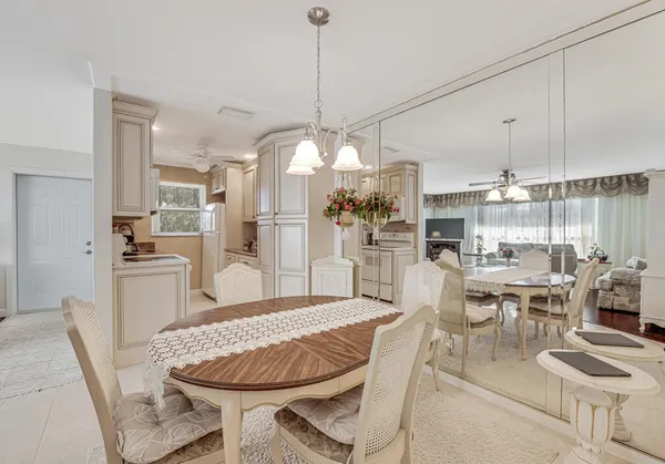 a large kitchen with a table and chairs