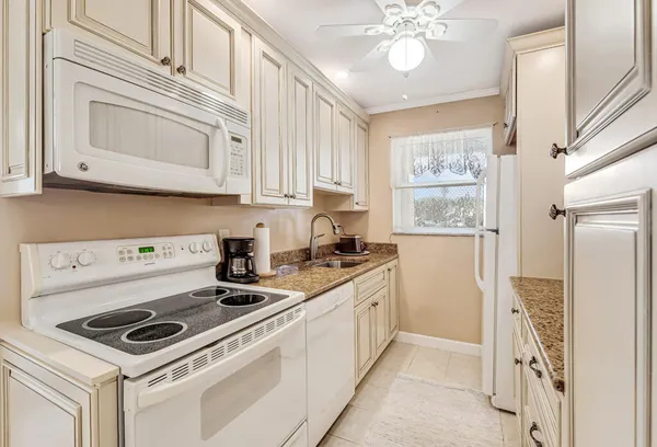 a kitchen with a stove cabinets and a refrigerator