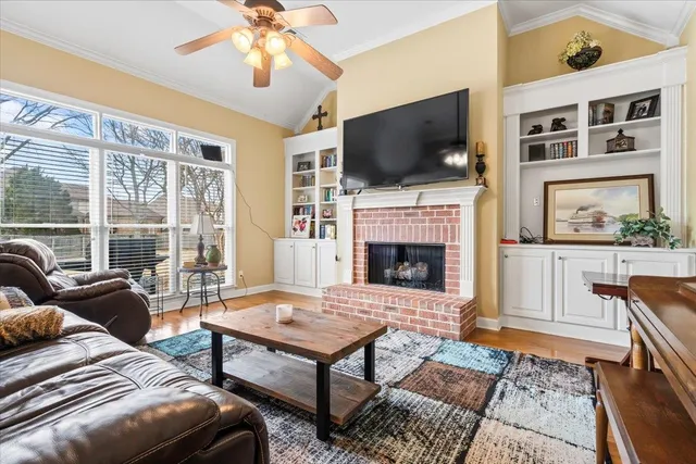 a living room with furniture a flat screen tv and a fireplace