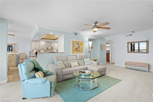 a living room with furniture a rug and a chandelier