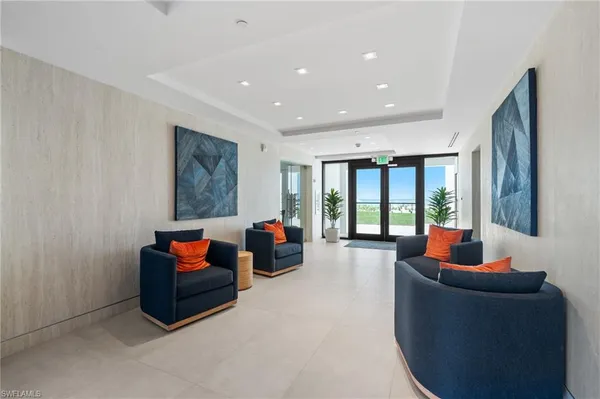 a living room with furniture and large windows