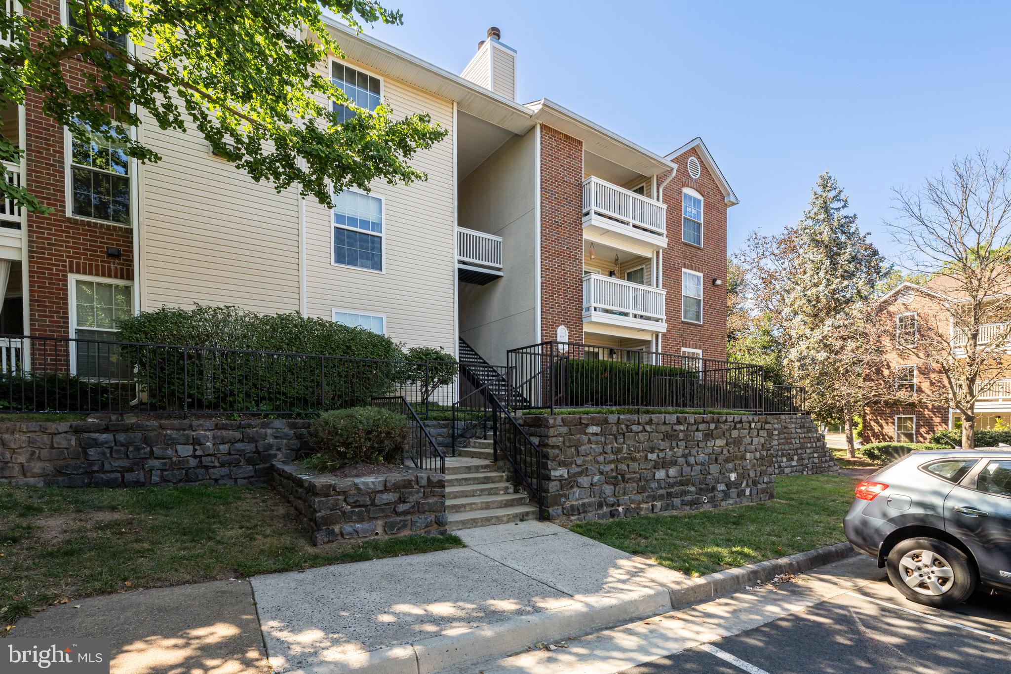 1539 Lincoln Way, Unit 302B McLean, VA 22102 - Photo 1 of 53 a front view of a house with a garden