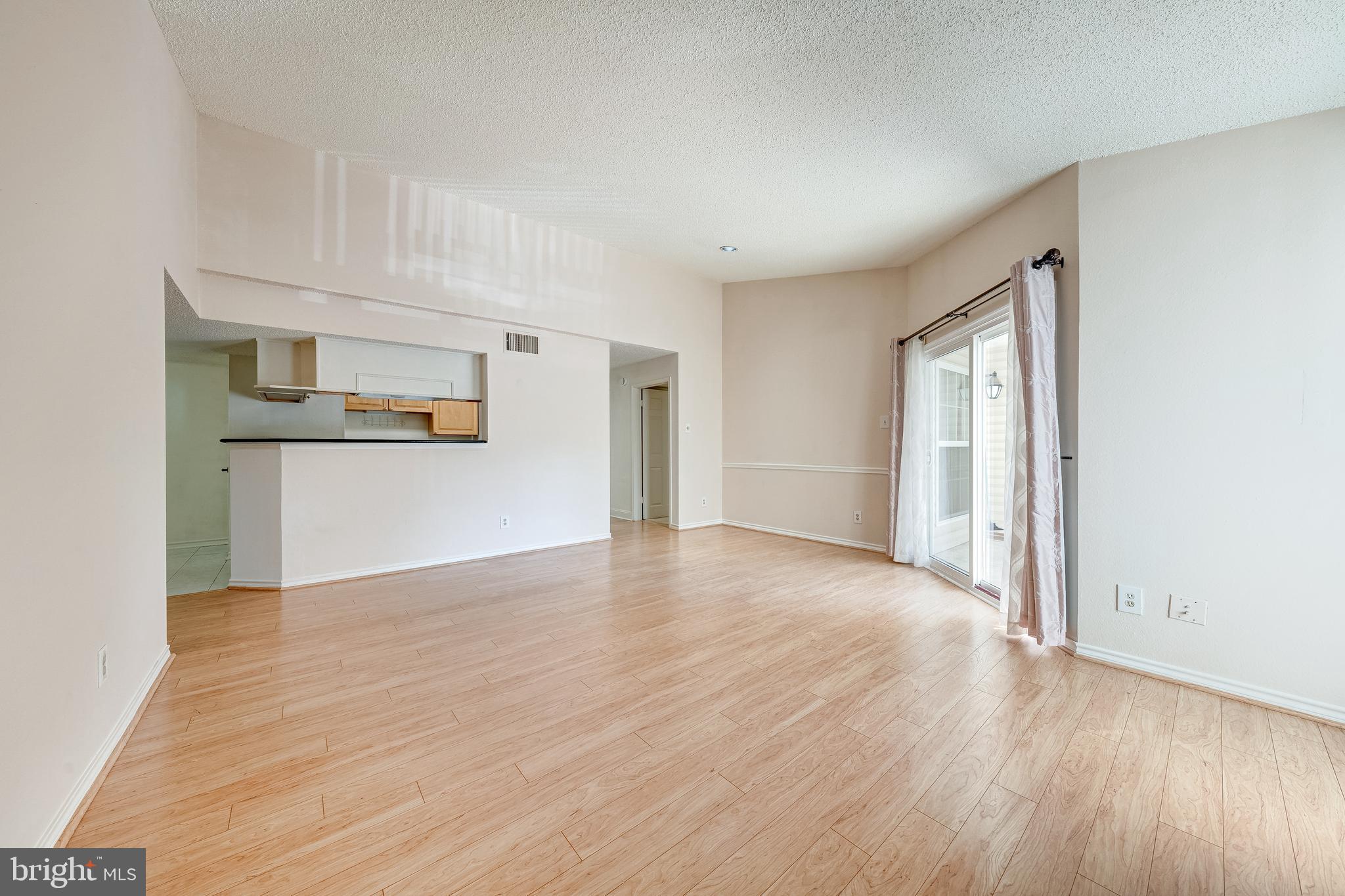 1539 Lincoln Way, Unit 302B McLean, VA 22102 - Photo 11 of 53 a view of a kitchen with wooden floor and a refrigerator