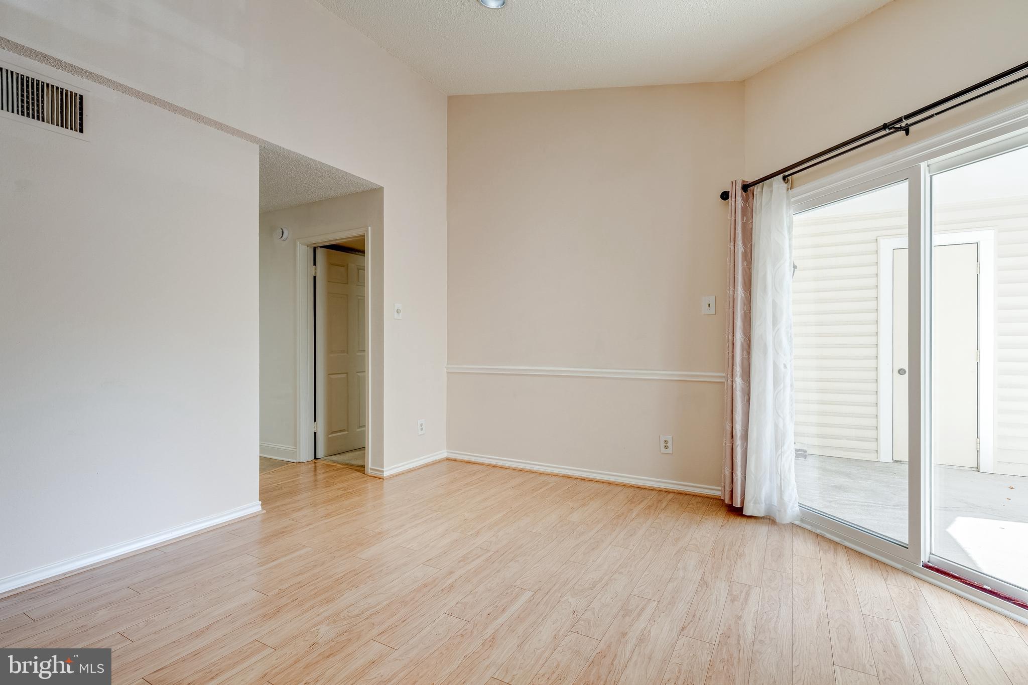 1539 Lincoln Way, Unit 302B McLean, VA 22102 - Photo 13 of 53 an empty room with wooden floor and windows