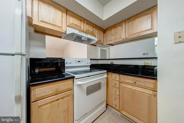 a kitchen with stainless steel appliances a refrigerator and a stove