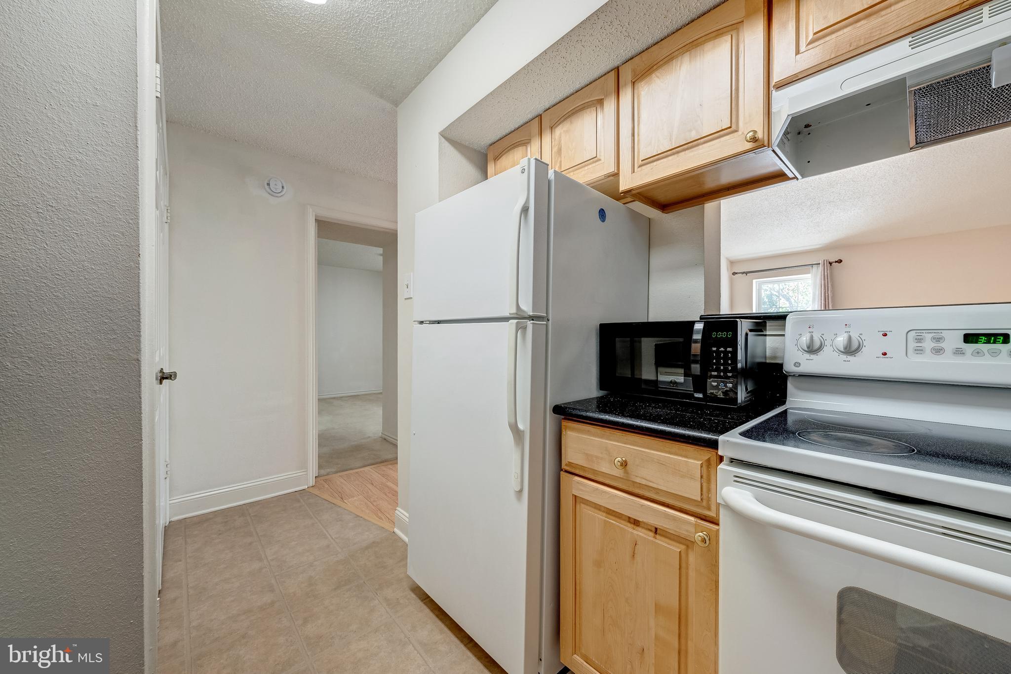 1539 Lincoln Way, Unit 302B McLean, VA 22102 - Photo 18 of 53 a kitchen with stainless steel appliances a refrigerator and a stove