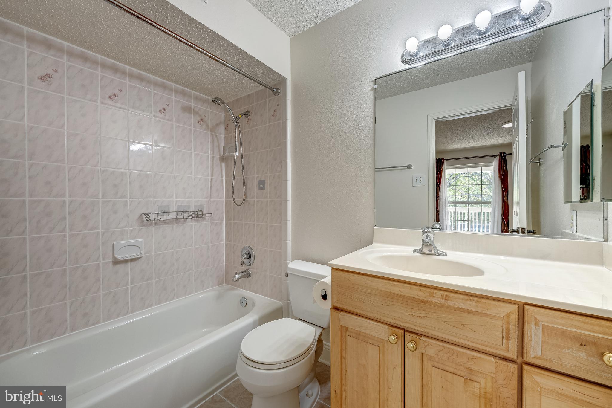 1539 Lincoln Way, Unit 302B McLean, VA 22102 - Photo 23 of 53 a bathroom with a sink mirror toilet and bathtub