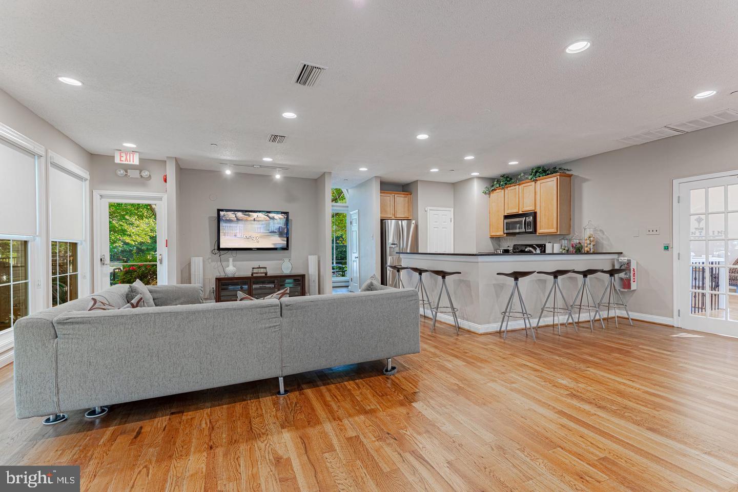 1539 Lincoln Way, Unit 302B McLean, VA 22102 - Photo 47 of 53 a living room with furniture and kitchen view with wooden floor