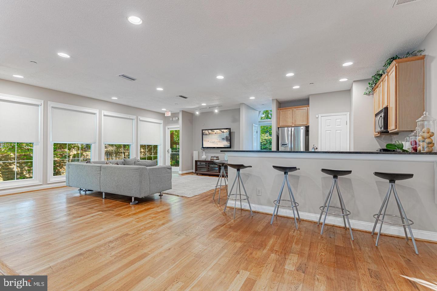 1539 Lincoln Way, Unit 302B McLean, VA 22102 - Photo 48 of 53 a living room with stainless steel appliances kitchen island lots of furniture and wooden floor