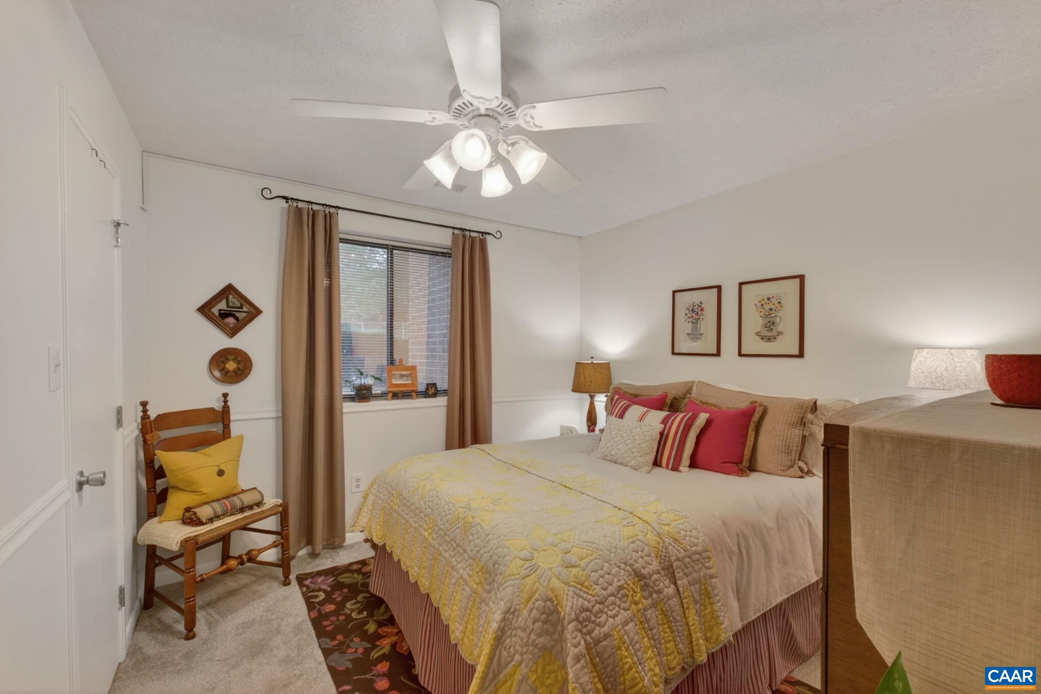 114 Turtle Creek Road, Unit 4 Charlottesville, VA 22901 - Photo 16 of 41 a bedroom with a bed and a chandelier
