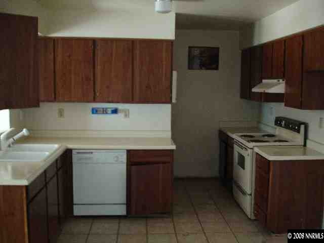 6555 Fern Street Reno, NV 89506 - Photo 5 of 9 a kitchen with a sink stove and cabinets