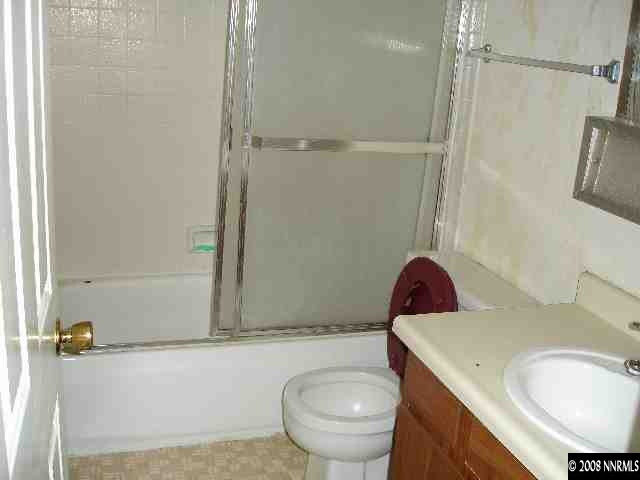 6555 Fern Street Reno, NV 89506 - Photo 6 of 9 a bathroom with a sink a toilet and shower
