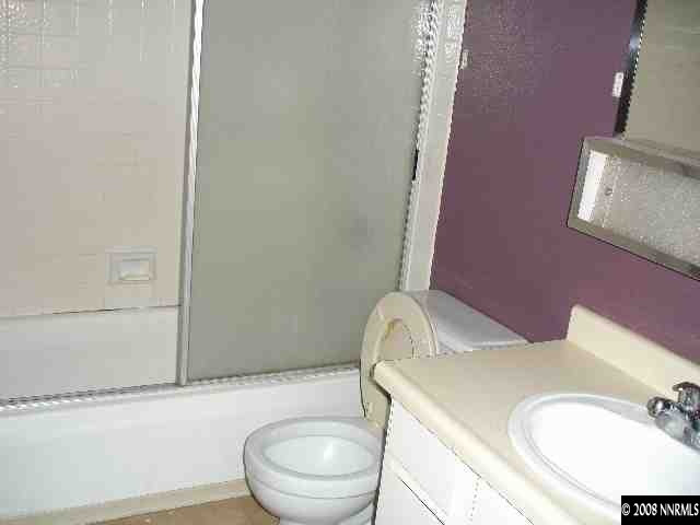 6555 Fern Street Reno, NV 89506 - Photo 9 of 9 a bathroom with a granite countertop toilet sink and mirror