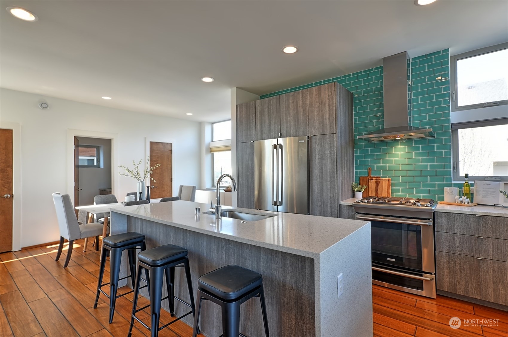 4453 Renton Avenue South Seattle, WA 98108 - Photo 7 of 25 a kitchen with stainless steel appliances granite countertop a dining table chairs and a refrigerator