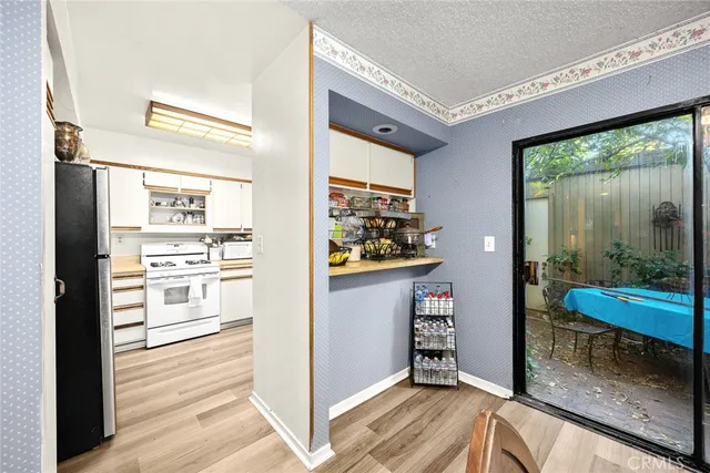 a view of a hallway with wooden floor and windows