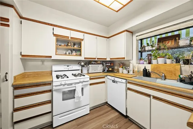 a kitchen with a stove a sink and a microwave