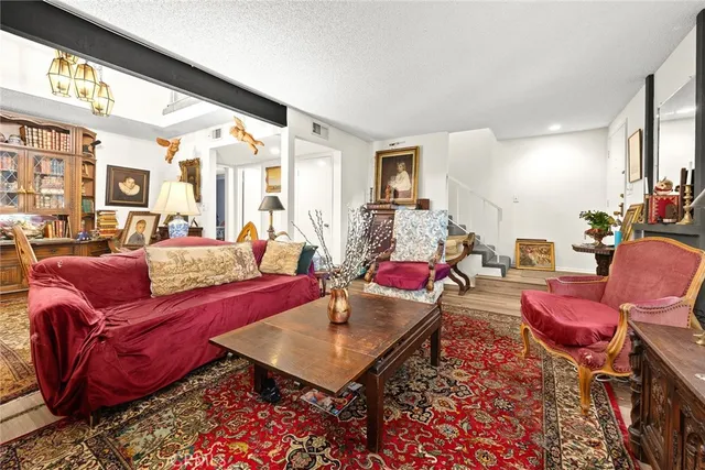 a living room with furniture a rug and a large window