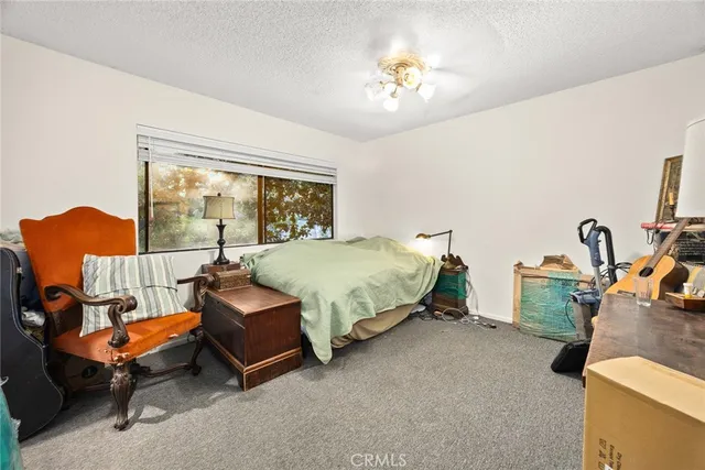 a bedroom with bed and window