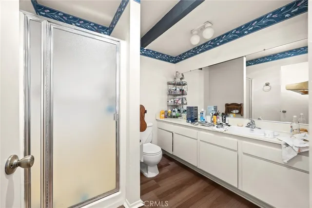 a bathroom with a double vanity sink toilet and shower
