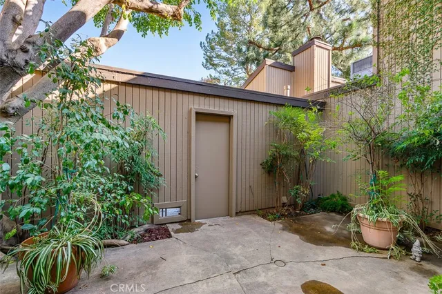 front view of a house with potted plants