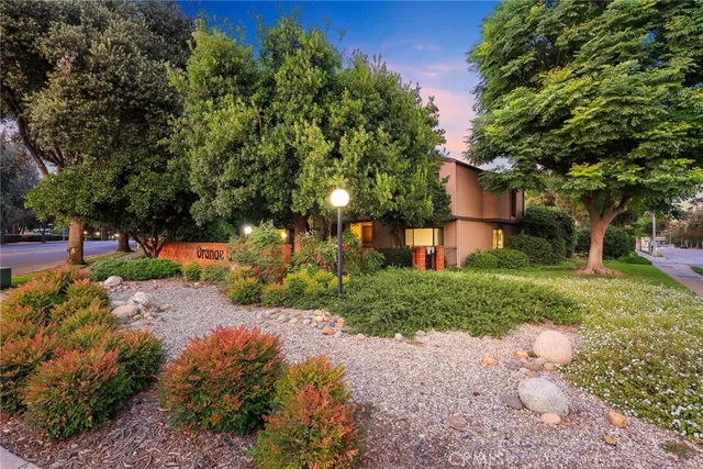 a view of a house with a yard and tree s