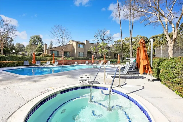 a view of a swimming pool with outdoor seating