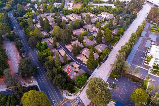 an aerial view of a house with garden space and street view