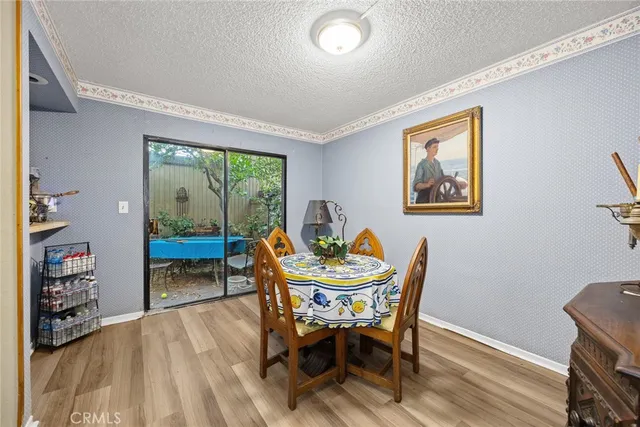 a dining room with furniture and a floor to ceiling window