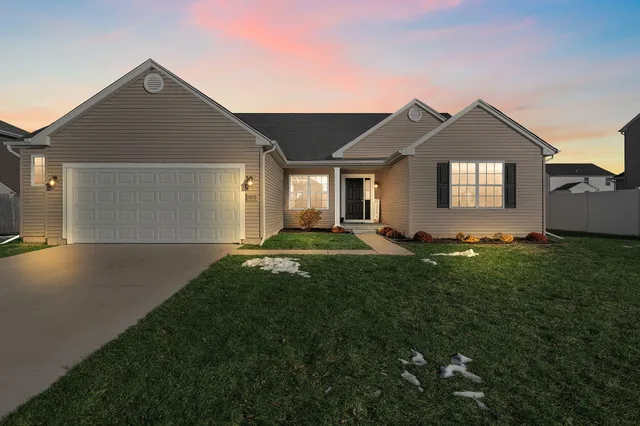 a front view of house with yard and green space