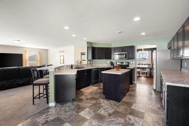 a large kitchen with a table and chairs