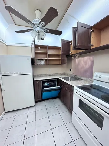 a kitchen with stainless steel appliances granite countertop a sink a stove a microwave and cabinets