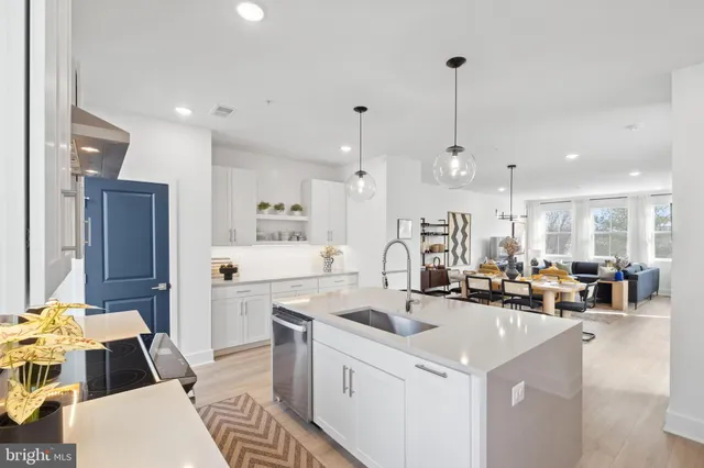 a kitchen with stainless steel appliances granite countertop a stove and a refrigerator