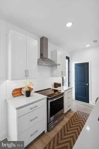 a kitchen with kitchen island a sink stove and refrigerator