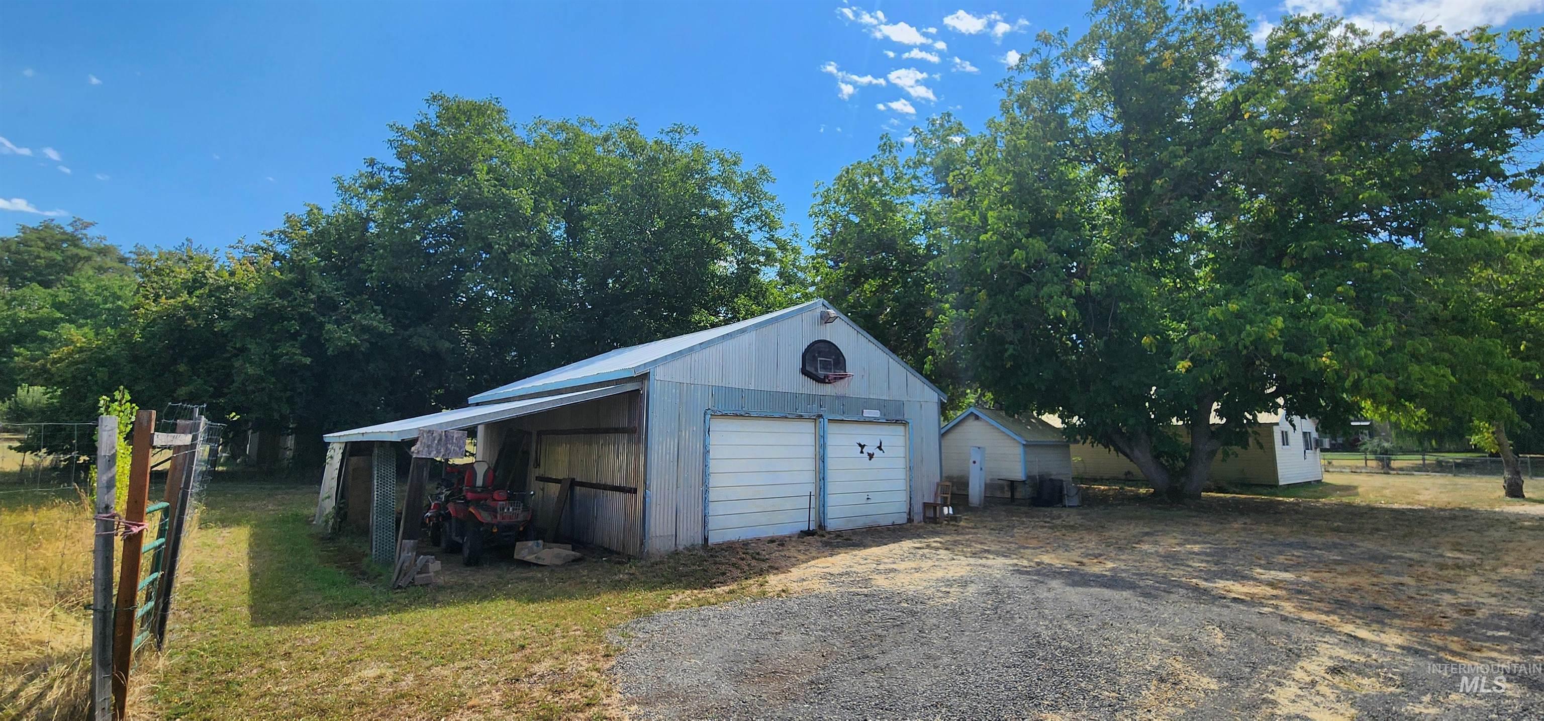 126 Rock Road Kamiah, ID 83536 - Photo 13 of 35 Garage with a detached garage and gravel driveway
