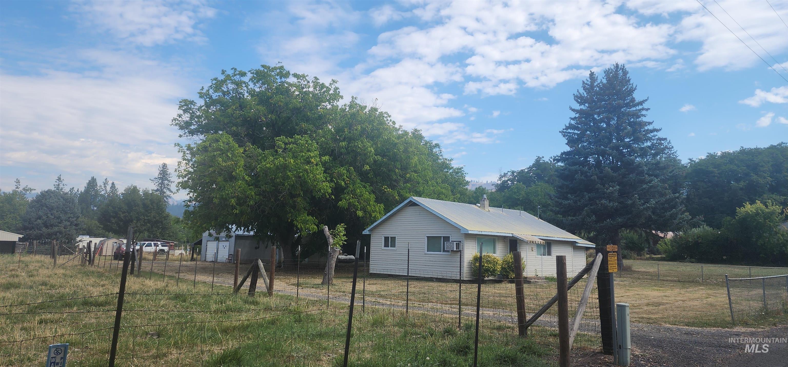 126 Rock Road Kamiah, ID 83536 - Photo 2 of 35 View of side of home with a metal roof, a view of rural / pastoral area, and view of scattered trees