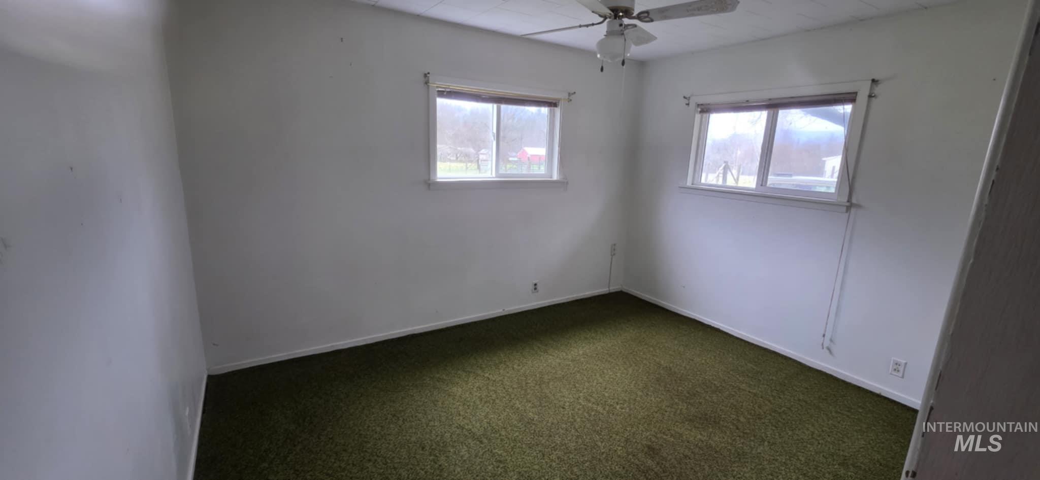126 Rock Road Kamiah, ID 83536 - Photo 25 of 35 Spare room with ceiling fan and dark colored carpet