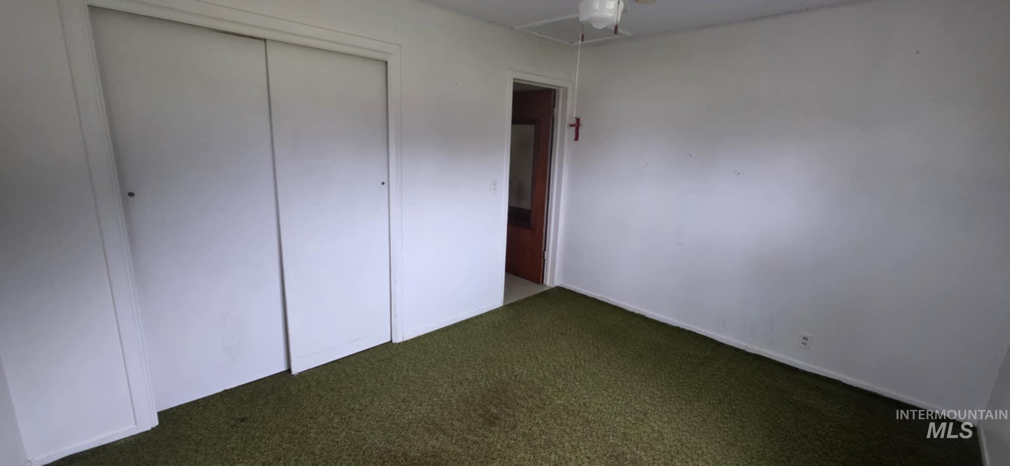 126 Rock Road Kamiah, ID 83536 - Photo 26 of 35 Unfurnished bedroom with carpet floors, a closet, and ceiling fan