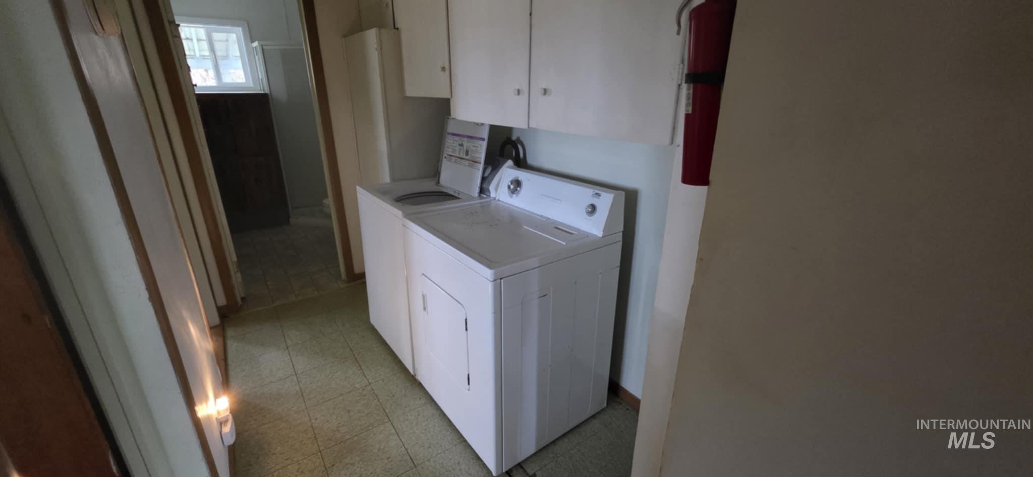 126 Rock Road Kamiah, ID 83536 - Photo 27 of 35 Laundry room featuring cabinet space, independent washer and dryer, and light flooring