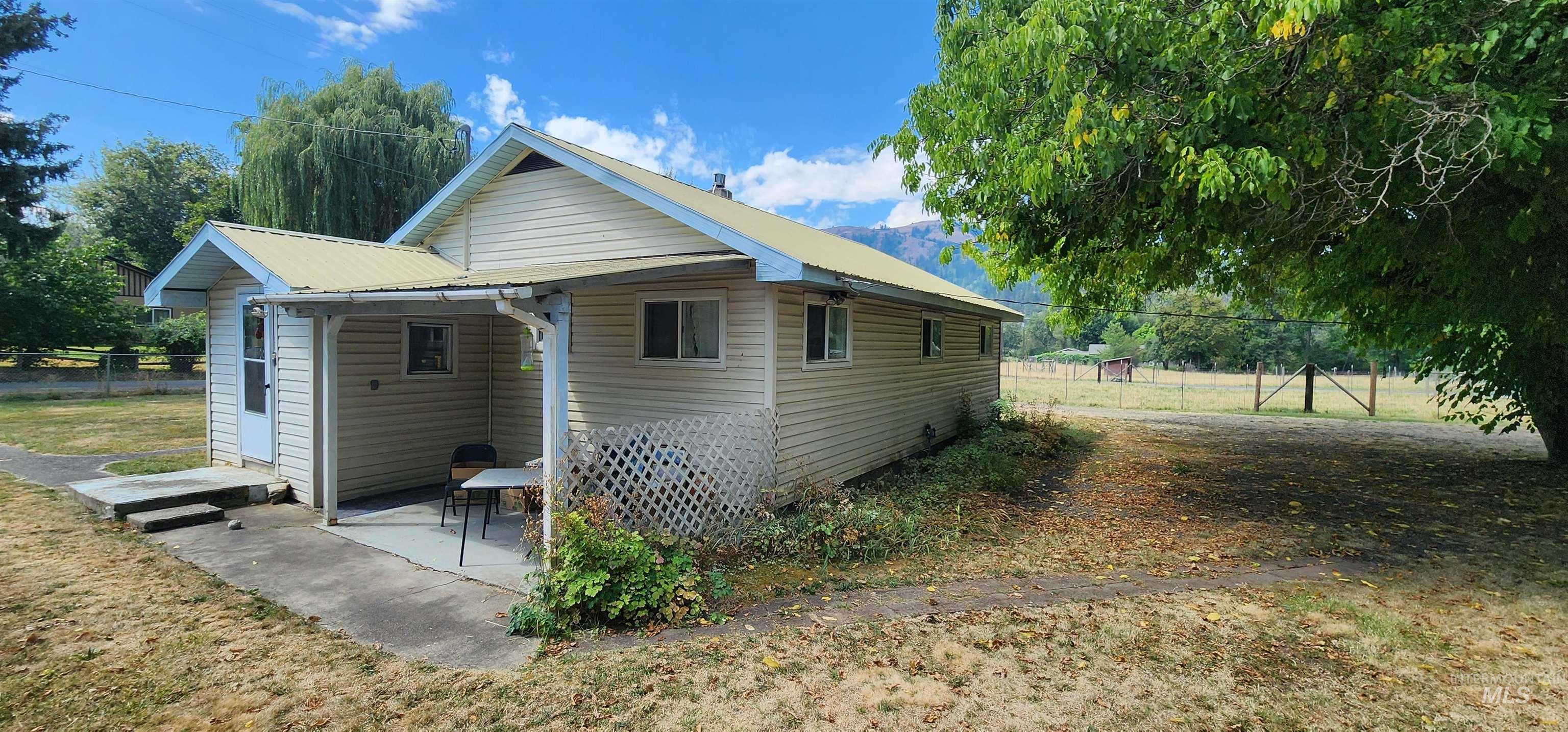 126 Rock Road Kamiah, ID 83536 - Photo 7 of 35 Rear view of property featuring a metal roof and a patio area