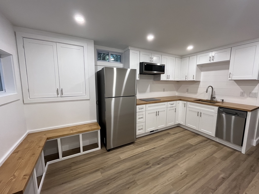 76 Sippewissett Road Falmouth, MA 02540 - Photo 23 of 28 a kitchen with stainless steel appliances granite countertop a refrigerator sink and microwave