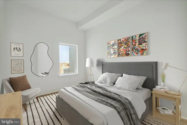 a bedroom with a bed and a painting on the wall